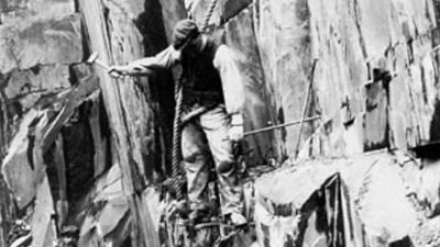 Quarry worker on rope