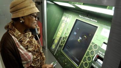 Woman stands in front of "ATM pharmacy"