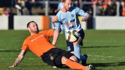 Action from Carrick Rangers against Ballymena United