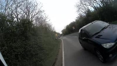 Cyclist helmet camera footage of the car swerving