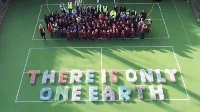 Children at St Edward's Prep in Reading took 45 minutes to arrange bottles into the line: "There is only one Earth."