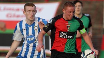 Coleraine's Rodney Brown attempts to win the ball from Glentoran's Stephen McAlorum