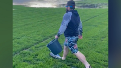 Man wears flippers on football pitch