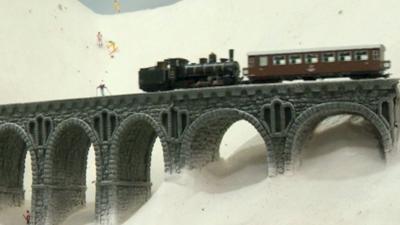 The exhibition has about 100 trains and more than 10,000 miniature people.