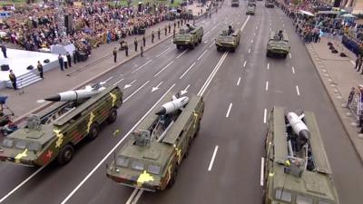 Military tanks and crowds