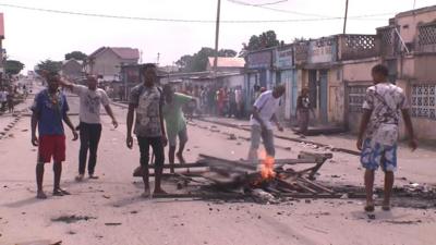 Demonstrators burn wooden pallets in the street