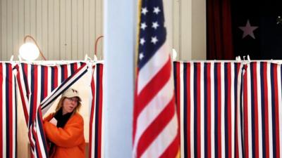 A woman exits a polling booth