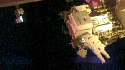 Astronauts embark on first spacewalk