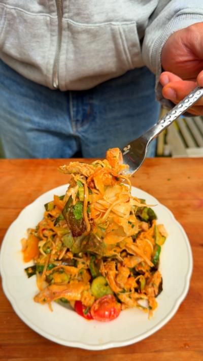 Rotisserie chicken salad on a plate with a forkful being lifted up