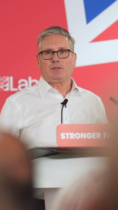 Keir Starmer giving a speech stood before a lectern 
