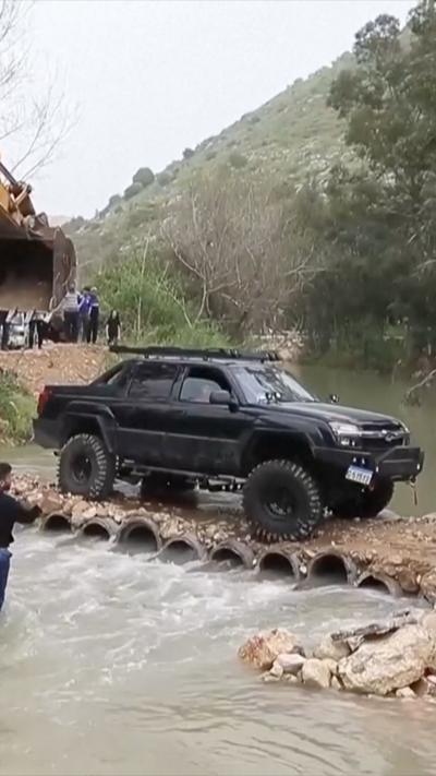 Large black vehicle crosses the Litani river in Lebanon