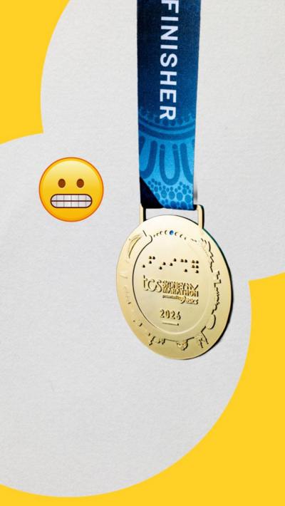 Sydney Marathon medal and an awkward face emoji