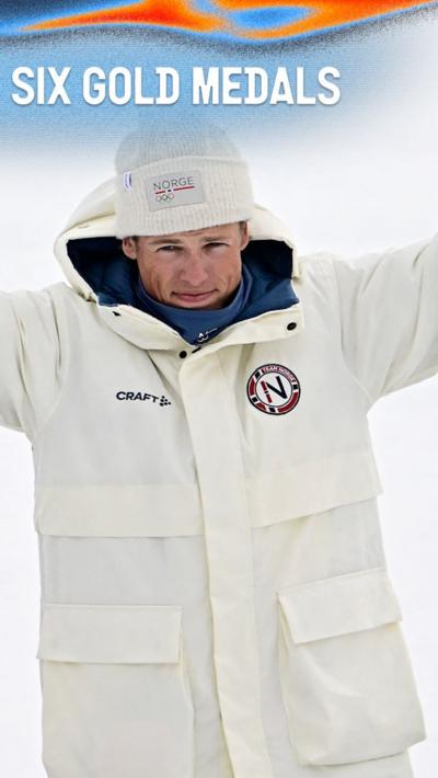 Johannes Klaebo smiles in white winter coat at the 2026 Winter Olympics