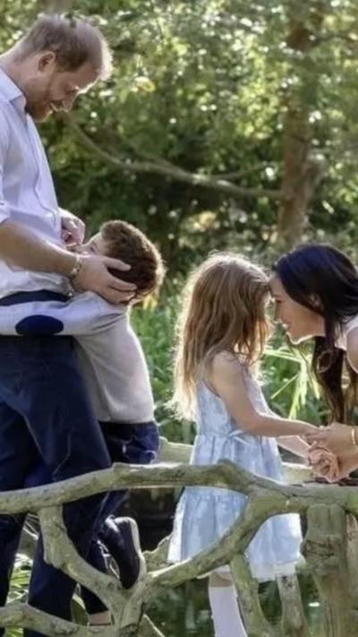Harry and Meghan with their two children in a park