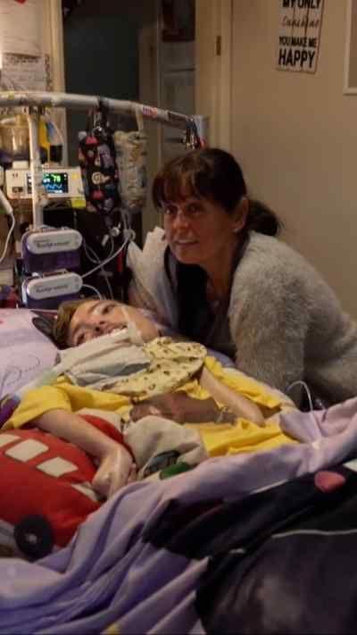 A woman with a disabled child in a hospital bed