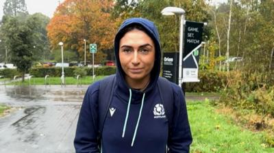 Emma Wassell, wearing a Scotland rugby hoodie, smiling at the camera