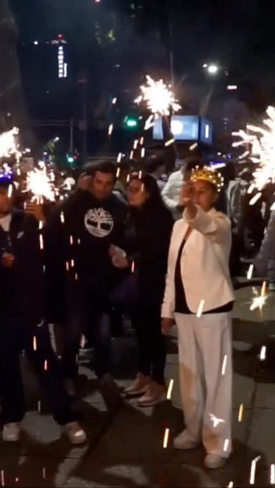 People hold sparklers in Mexico City street