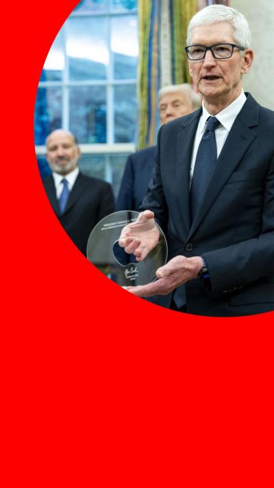 Apple's Tim Cook, wearing a suit, holding a glass disc in the Oval Office, with President Trump behind him