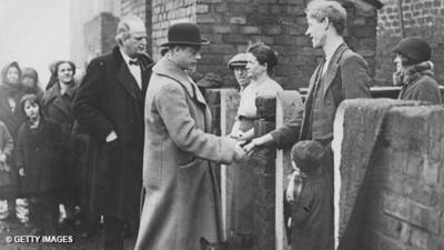 Edward, Prince of Wales (later King Edward VIII), shakes hands with a coal miner at Middlestone Moor during his coalfields tour of 1929.