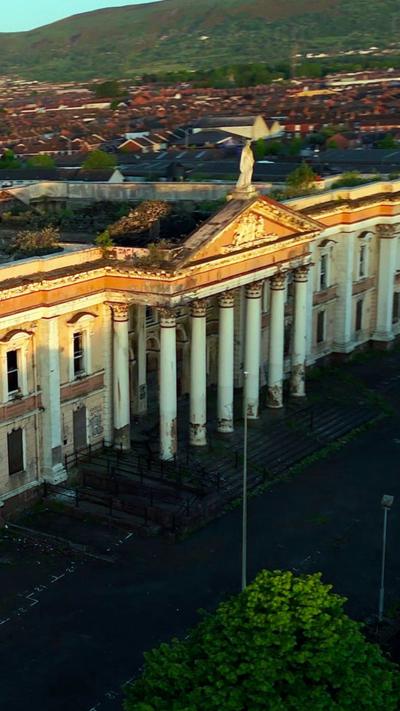 Crumlin Road Courthouse - the shot is of the columned portico with the figure of justice on the roof above the royal crest

