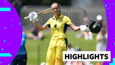 Australia's Ash Gardner raises her bat after scoring a century