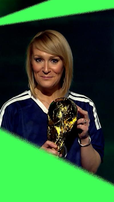 Woman in Scotland top with the World Cup