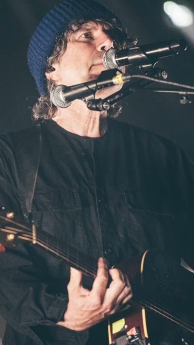Gruff Rhys on the Eisteddfod stage singing and playing the guitar