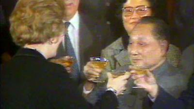 Prime Minister Margaret Thatcher holds up  a drink with Zhao Ziyang.