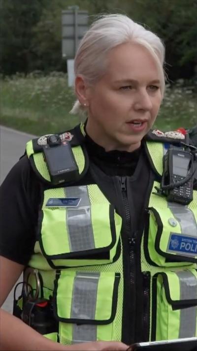 Lucy D'Orsi has blonde short hair in a ponytail and wears a BTP police vest