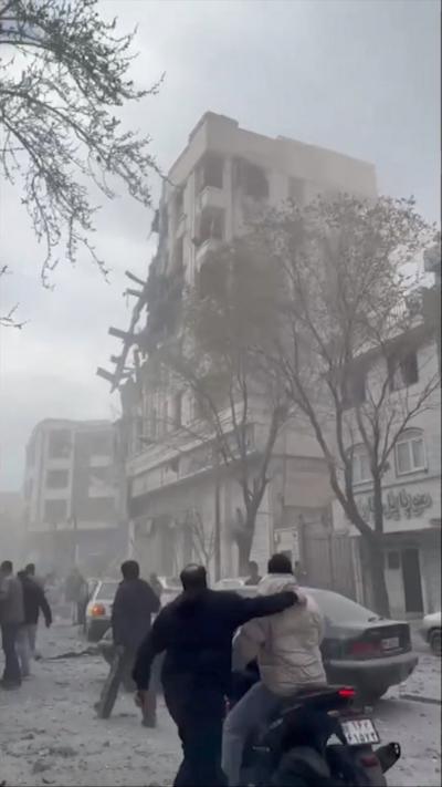 A damaged building in Tehran, debris is on the street
