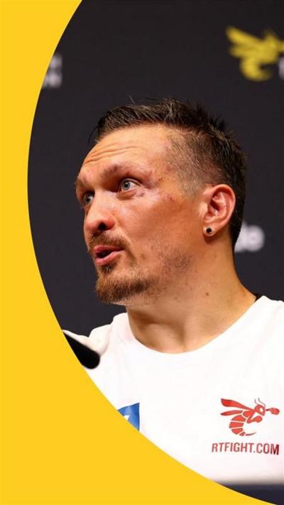 Usyk with a bruised face talking at a news conference