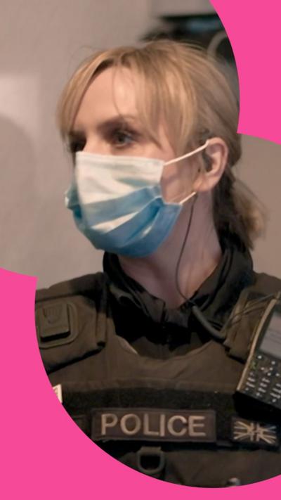 A police woman wearing a face mask