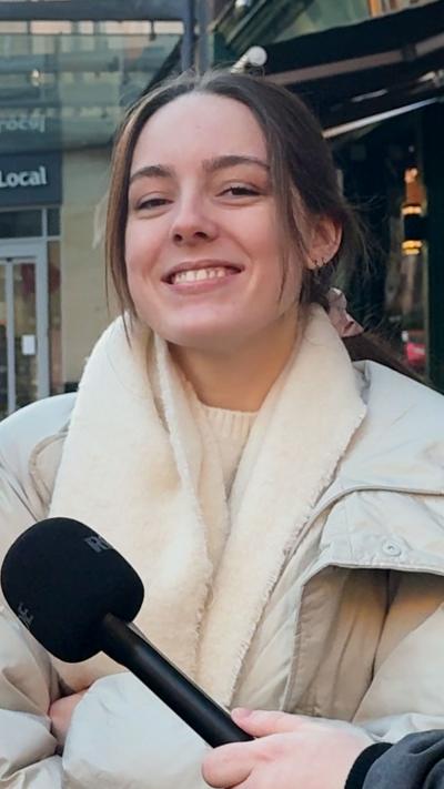 A young woman in the west end of Glasgow smiling at the camera