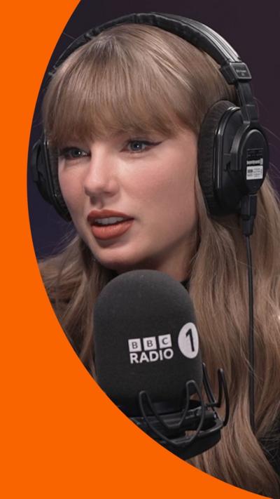 Taylor Swift in the Radio 1 studio, speaking into a BBC Radio 1-branded mic