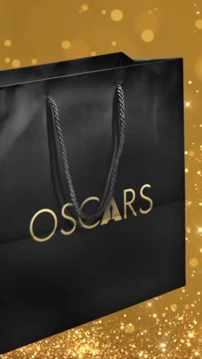 A black gift bag with the word 'Oscars' on the side