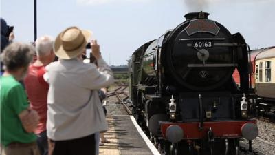 Onlookers snap pictures of the steam engine Tornado at Ferryside, Carmarthenshire