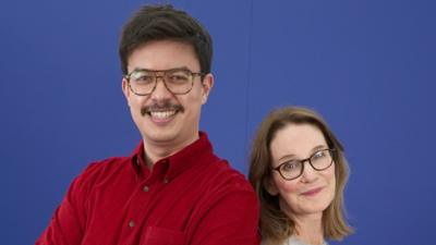 Susie Dent stans next to Phil Wang
