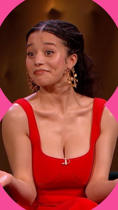 Chase Infiniti has long dark hair and is wearing a red sleeveless dress.