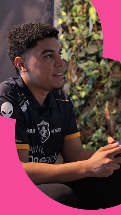 Esports player Levi holding a controller and looking at a screen