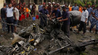 Emergency crews assessing a wreckage of a jet