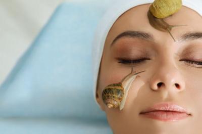 Woman with two snails on her face