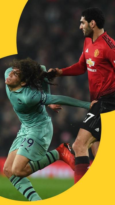 Matteo Guendouzi of Arsenal is pulled back by his hair by Marouane Fellaini 