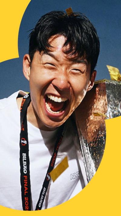 Son Heung-min smiles holding the Europa League trophy 