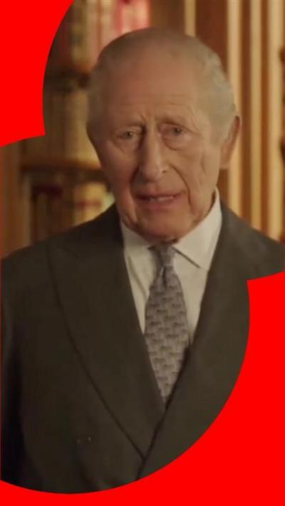 King Charles is wearing a grey suit with a white shirt and a lighter grey tie