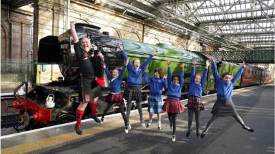 Dancers and pipers beside Flying Scotsman