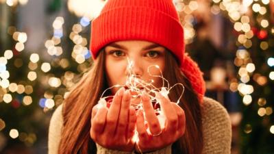 A woman holding LED lights