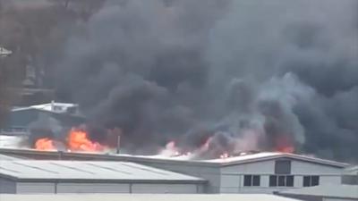 Fire comes through roof of Andover warehouse