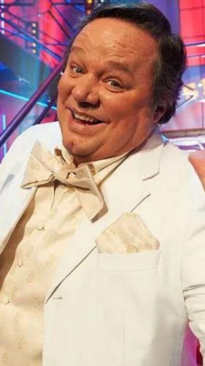 Smiling man in a white suit