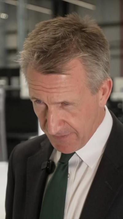 Dan Jarvis in a suit looking down as he speaks during an interview.