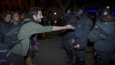 Catalan riot police and protesters clash during a protest at the headquarters of the Spanish Government Delegation in the Autonomous Community of Catalonia in Barcelona, northern Spain, 23 March